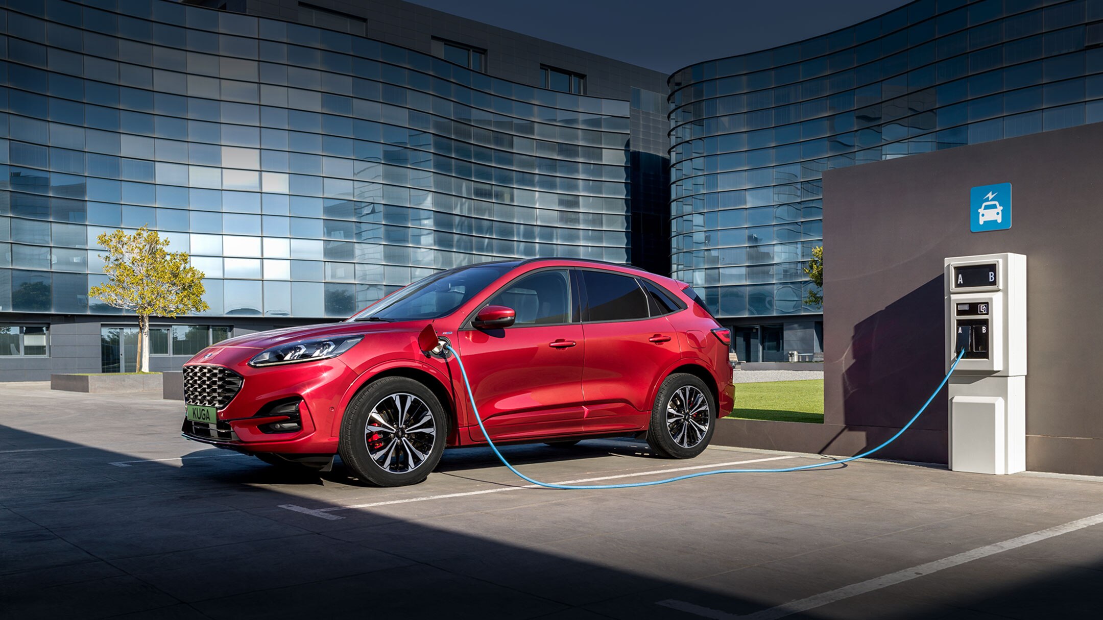 Ford red Kuga at the charging station side view