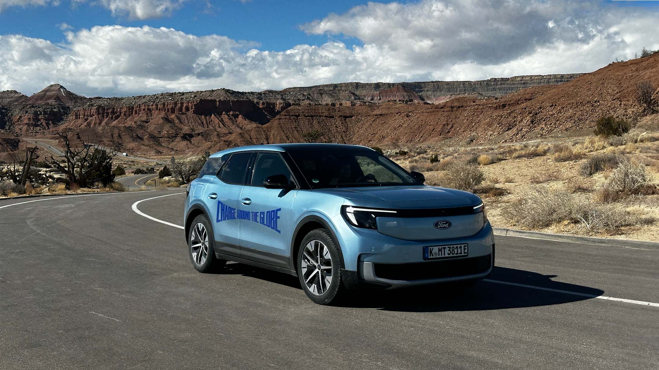 The electric Ford Explorer on a road with arid mountains in the background