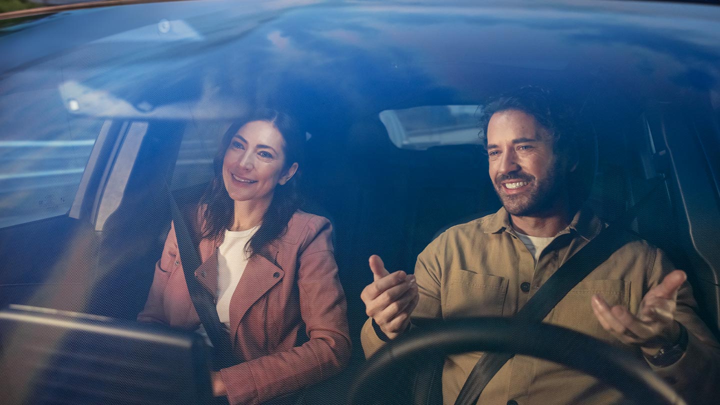 Két ember ül egy Ford első ülésén, bekötött biztonsági övvel