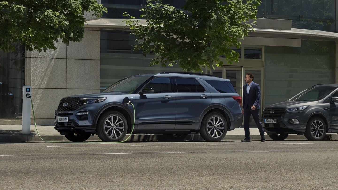 Man approaching Ford Explorer being charged