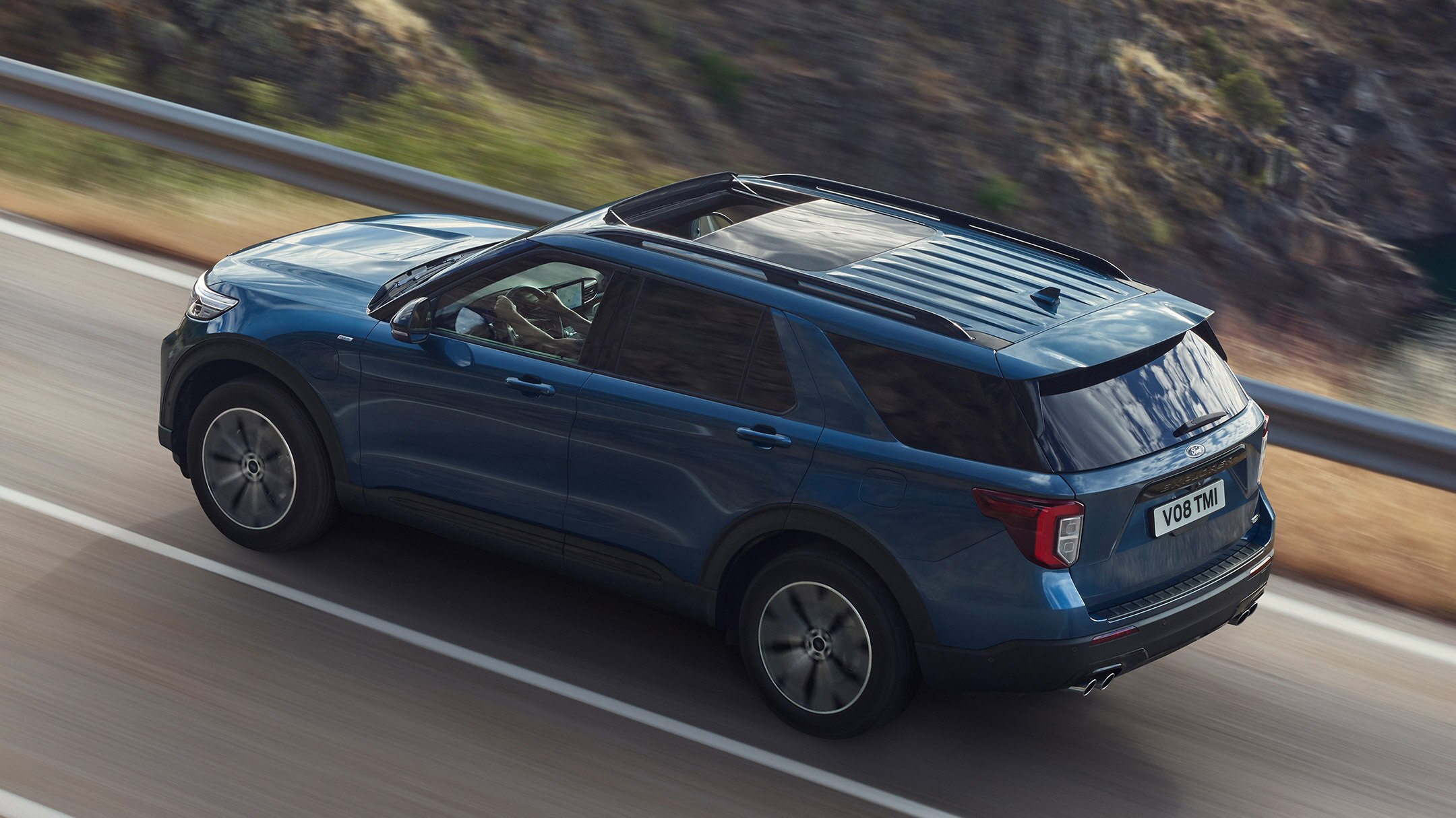 Ford Explorer driving on mountain road birds-eye view