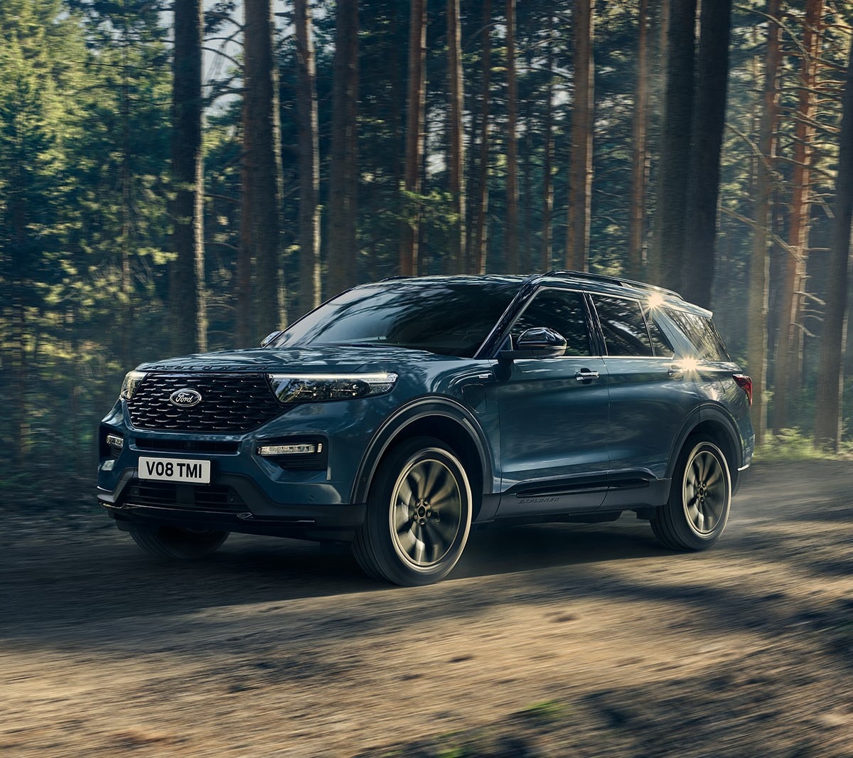 Ford Explorer in motion driving in the middle of forest