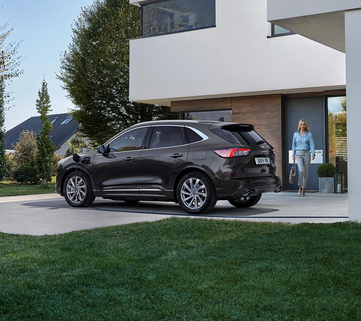 Blue Ford Kuga viewed from back with woman