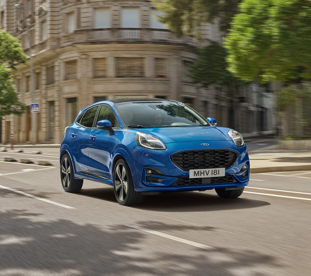 Blue Ford Puma driving in city