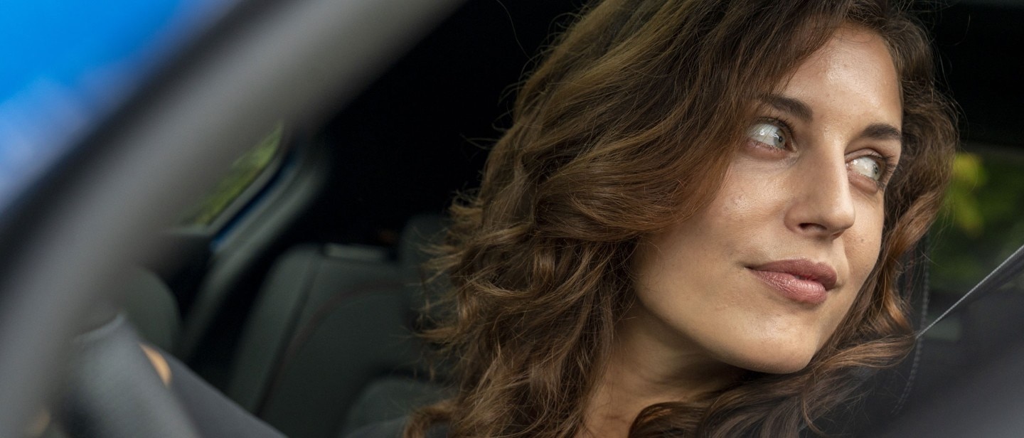 Woman looking out of a driver's window