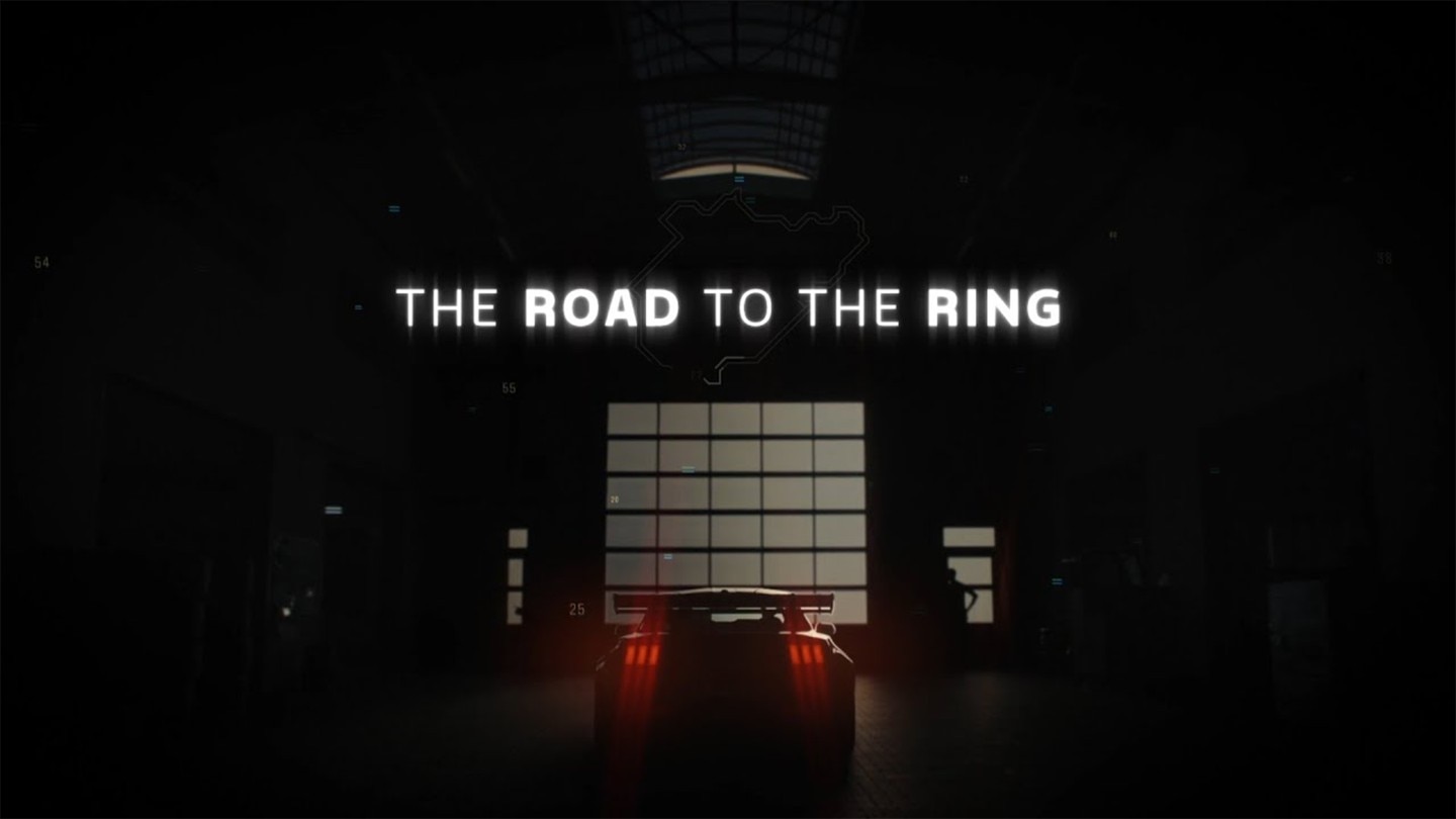 Ford Mustang GTD in a racing garage with "THE ROAD TO THE RING" text.