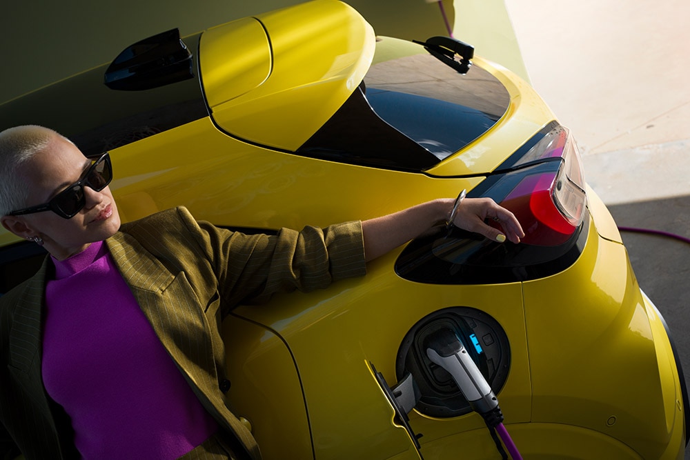 Közelkép egy otthoni Wallboxhoz csatlakoztatott elektromos Ford Puma Gen-E® hátsó részéről.