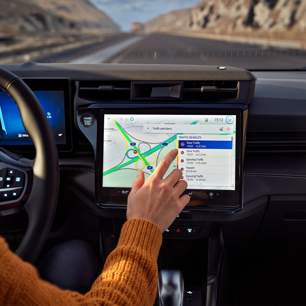 Egy Ford Puma BlueCruise Edition digitális kijelzőjén a vezető a Csatlakoztatott navigáció funkciót használja.