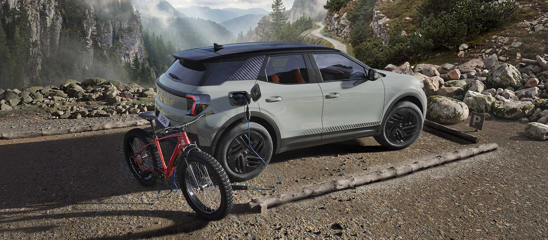Egy Ford Explorer®-ből töltődő elektromos kerékpár, háttérben hegyvidéki tájjal.