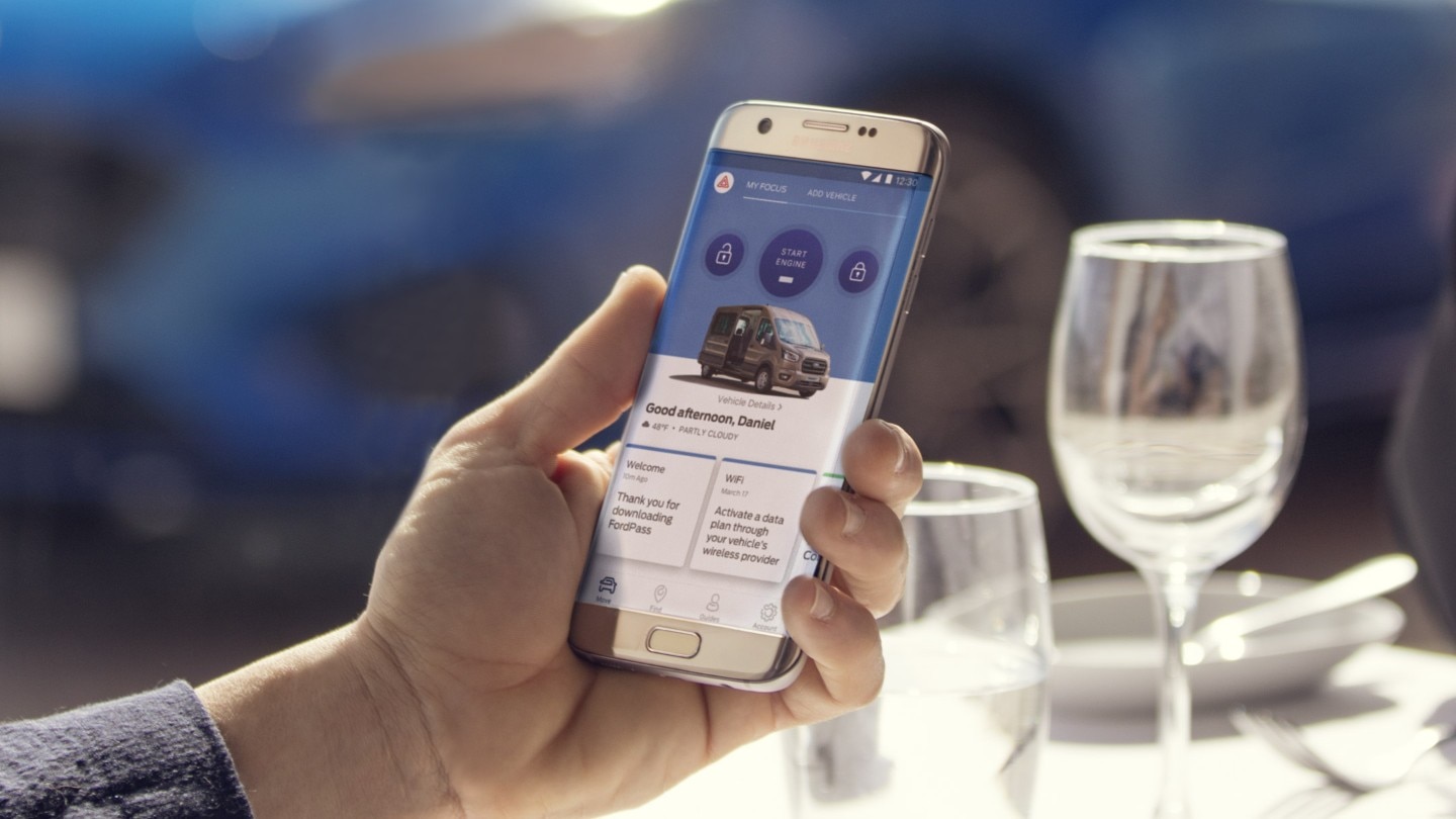 Hand with mobile showing FordPass Connect