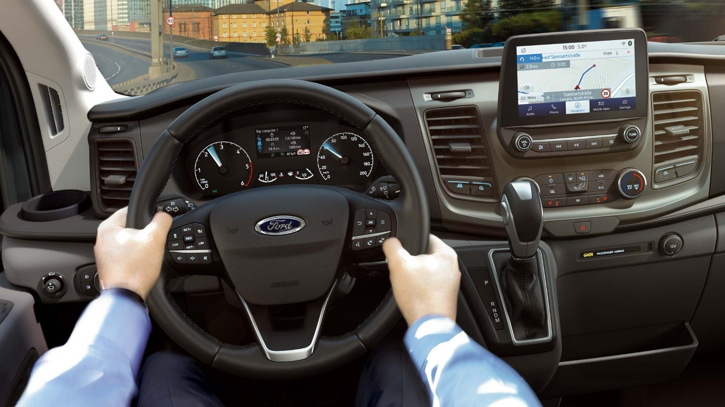 Ford Transit Minibus interior with hands on steering wheel