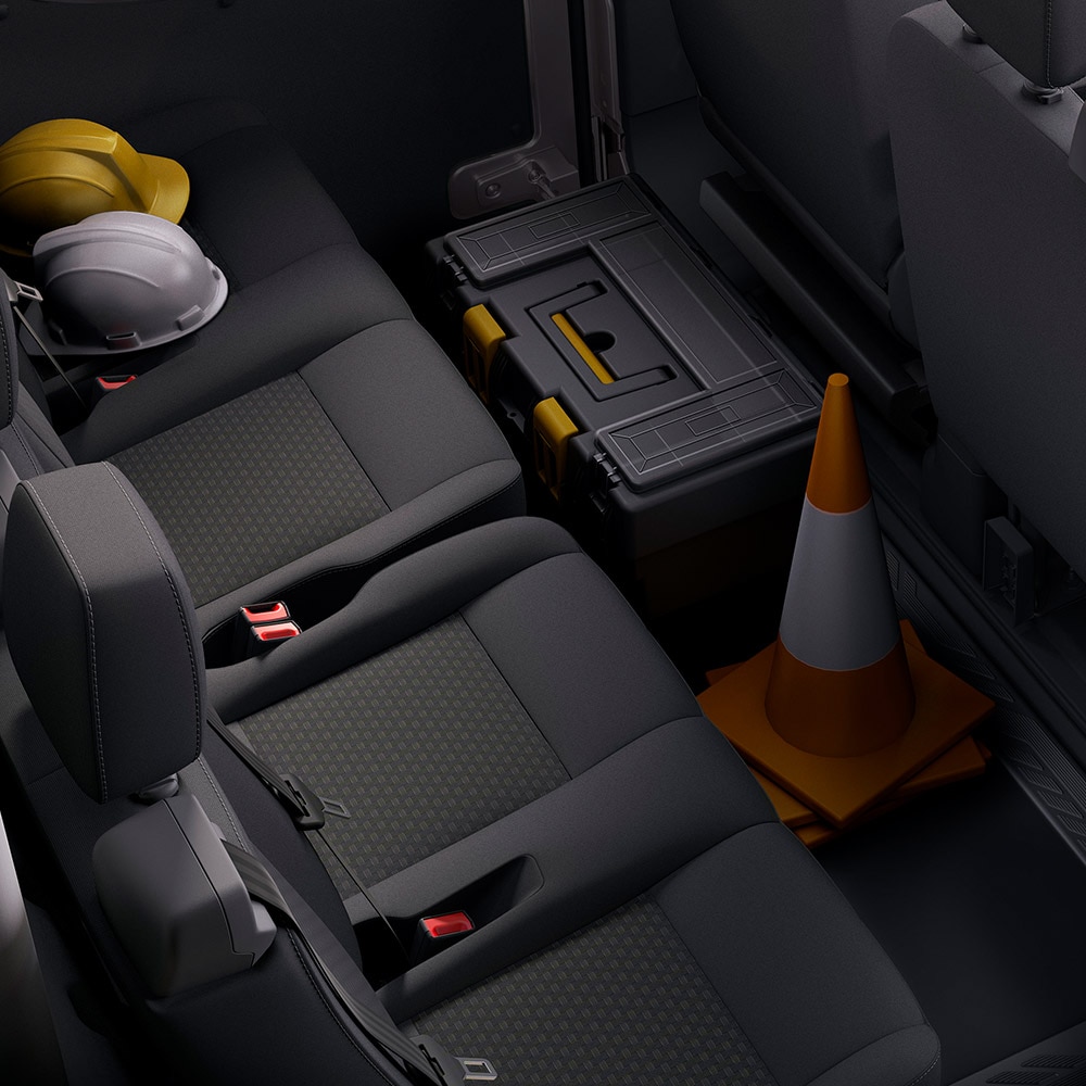 A row of dark gray seats with headrests and seatbelts.