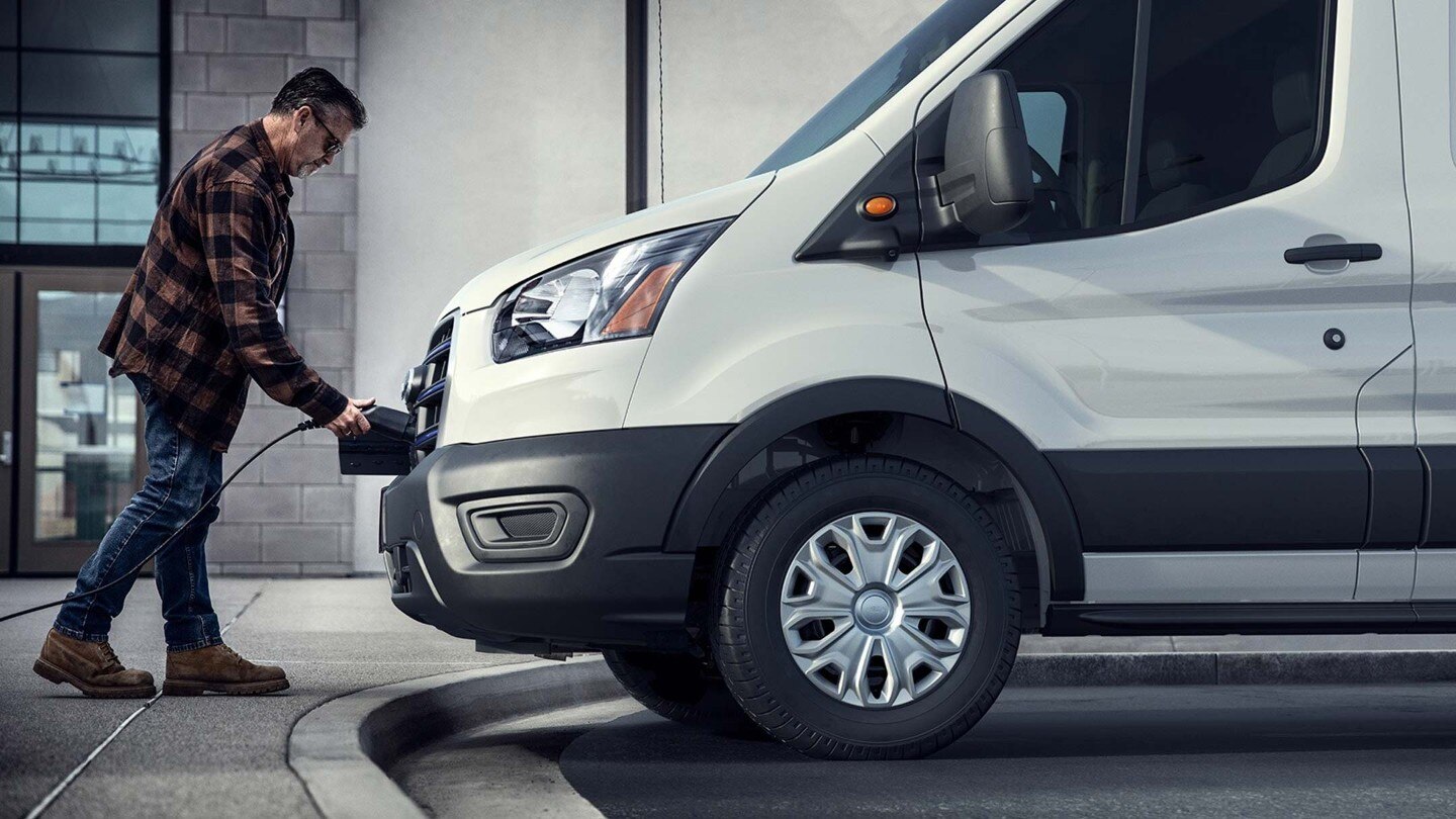 A man charging an E-Transit at a public charging point